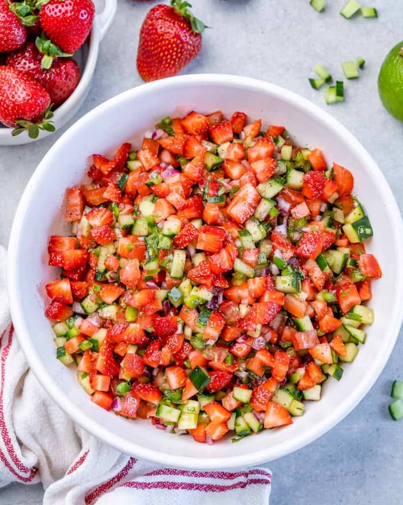 Top view of strawberry salsa in a round white bowl.