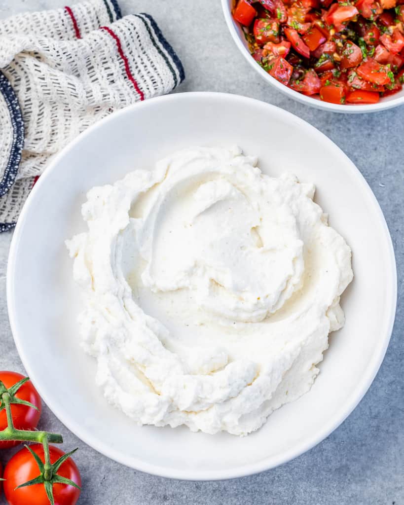 whipped ricotta cheese added on a plate 