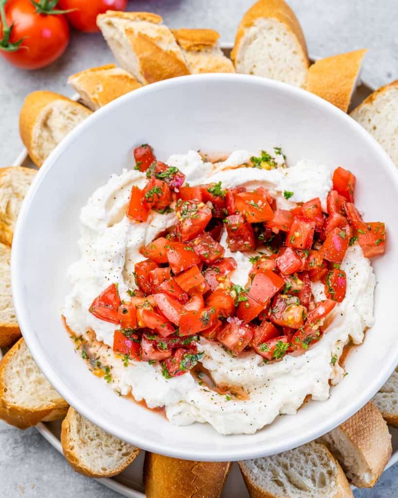 side shot of ricotta cheese dip topped with tomato balsamic blend