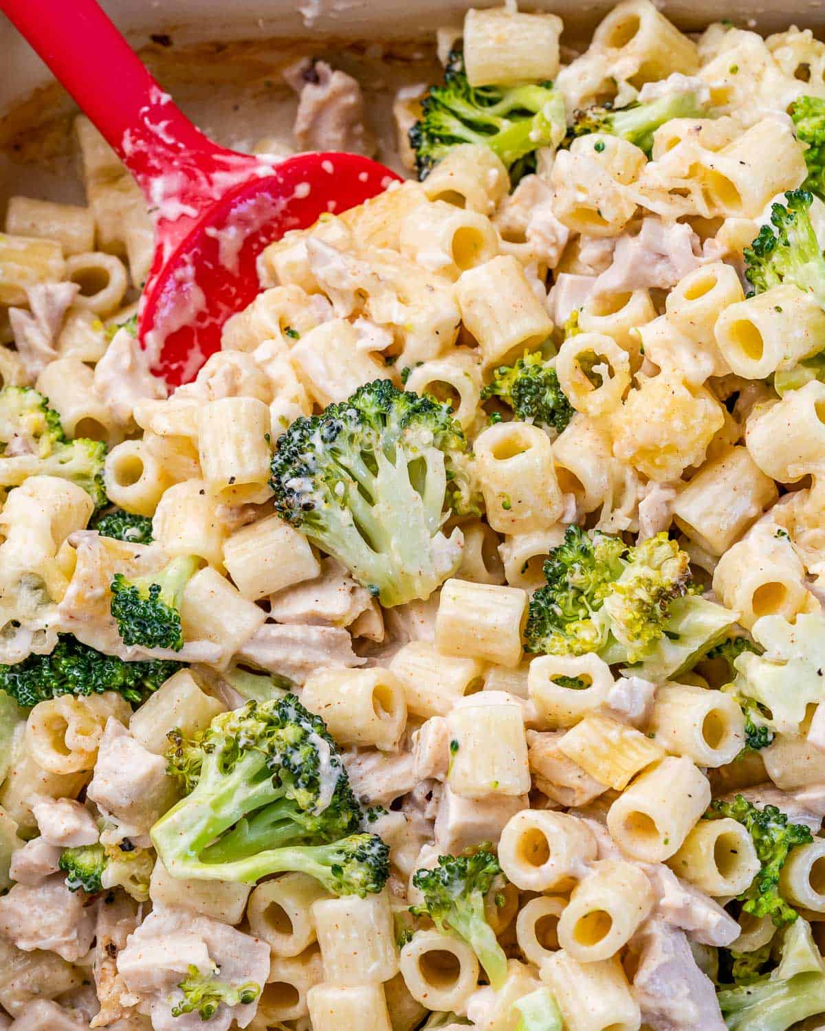 Dishing out a serving of pasta, broccoli and chicken casserole.