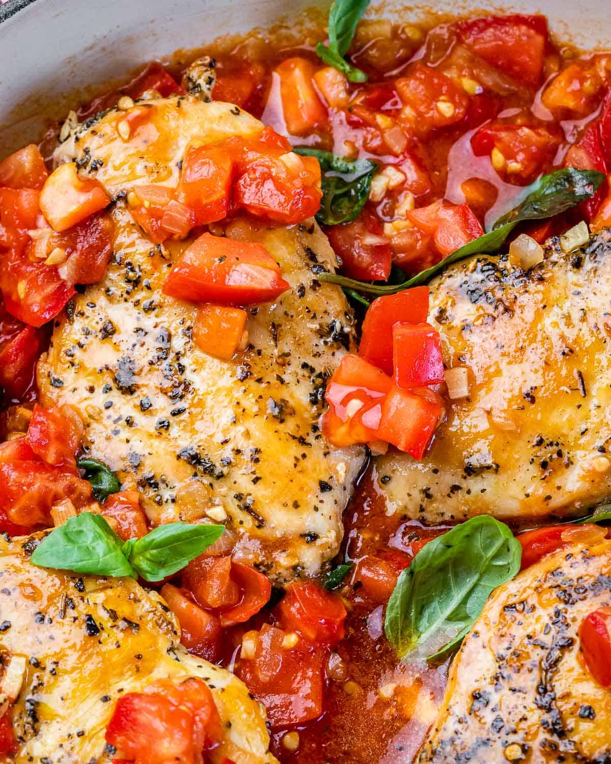 Seasoned chicken breasts topped with diced tomatoes and fresh basil.