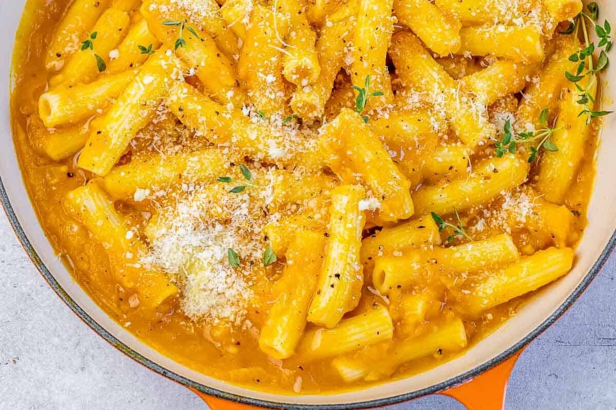 Creamy pumpkin pasta in a large pot.