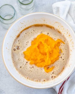 Mixing pumpkin puree with milk and eggs.