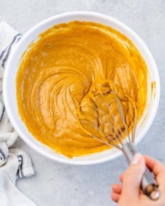 Stirring together batter for pumpkin bread.