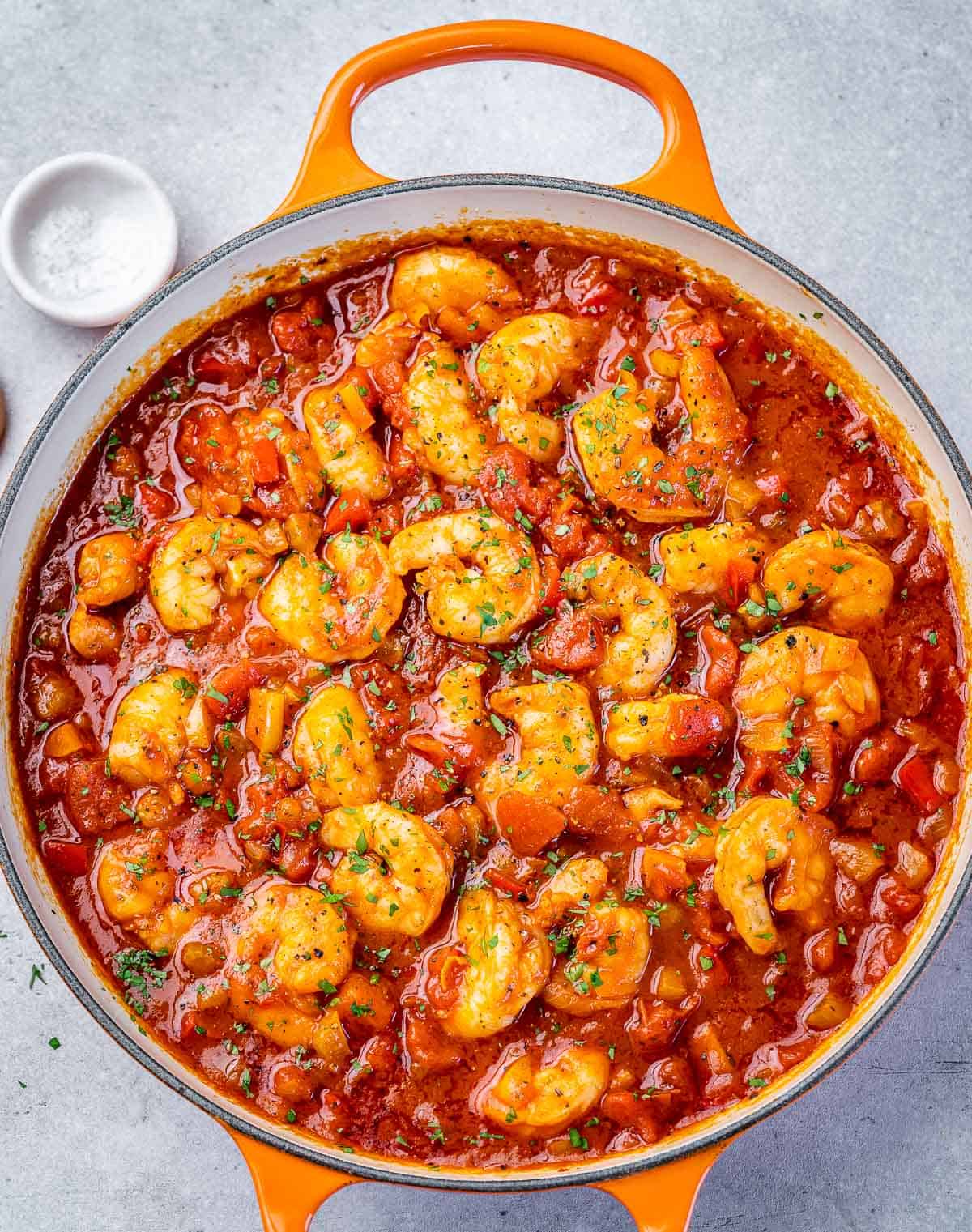 Cooking shrimp creole in a large pot.