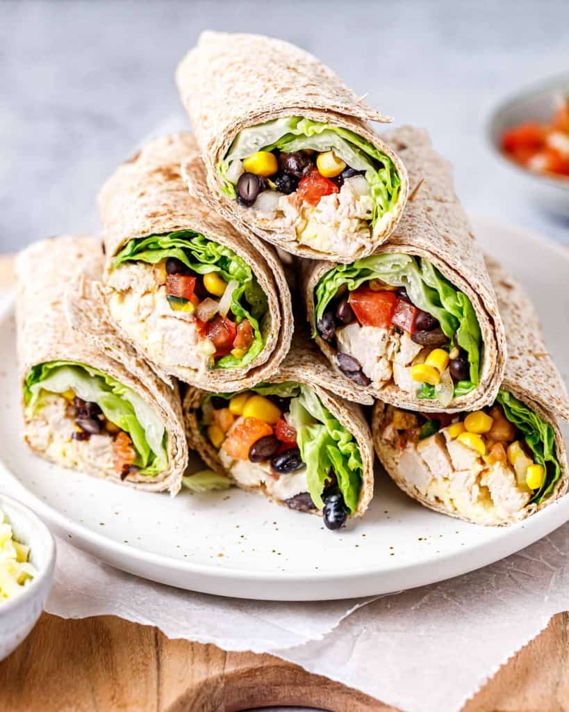 side shot of chicken wraps stacked over each other