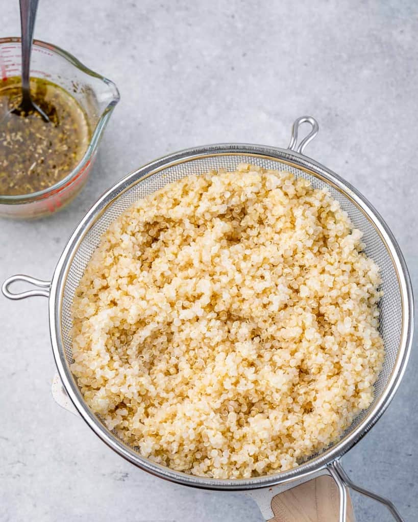 cooked quinoa in a colander