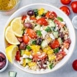 top view of a white bowl with quinoa greek based salad