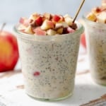 Side shot of a jar with overnight oats topped with chopped apples.