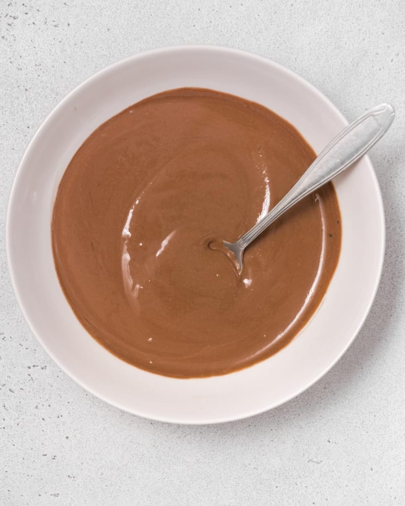Chocolate dip stirred together in a bowl.