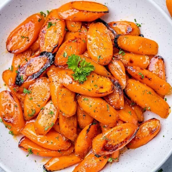 roasted honey glazed carrot bites on a white plate to be served.