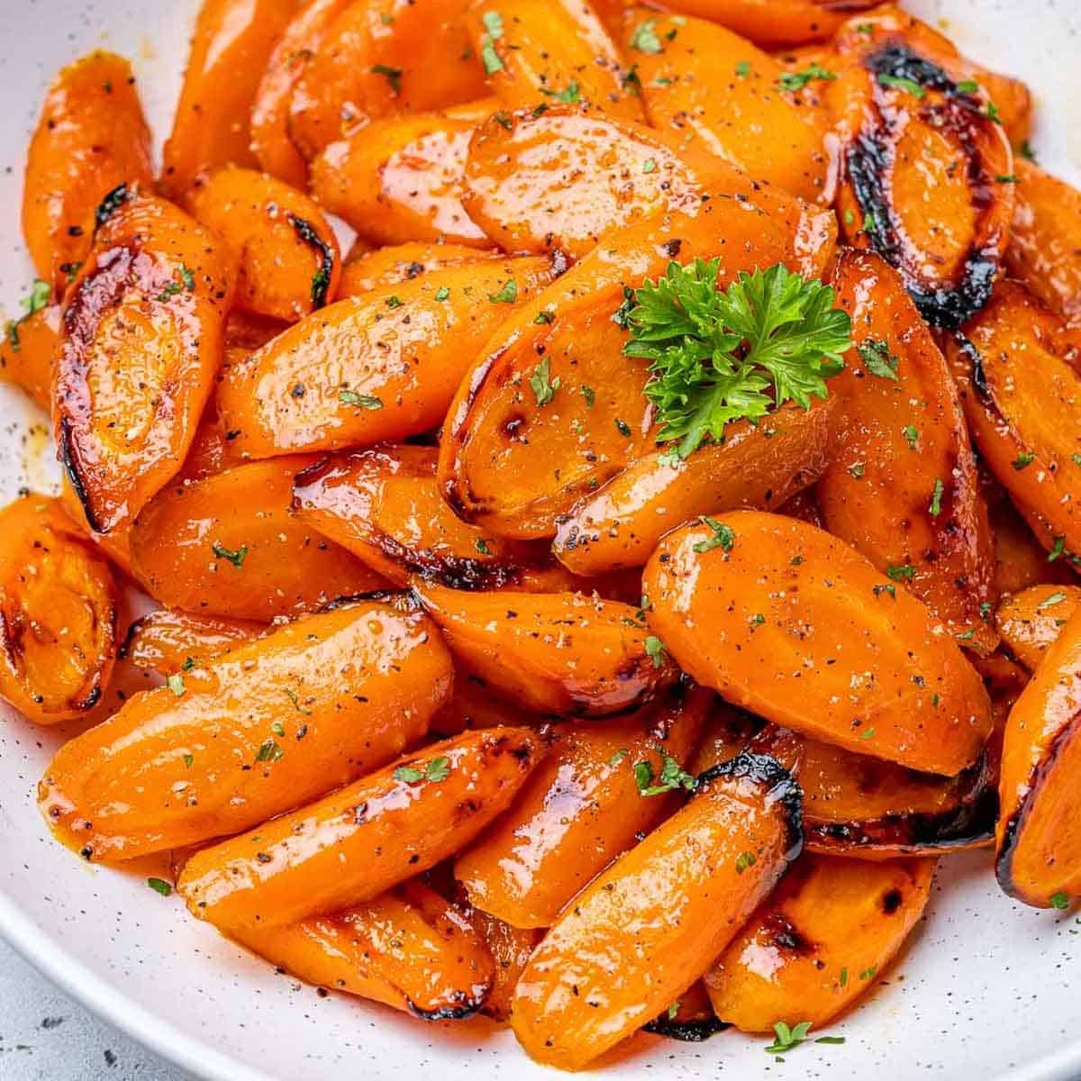 roasted glazed carrot bites on a white plate to be served.