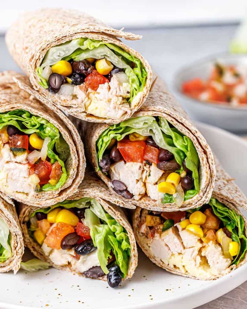 side shots of chicken wraps stacked over each other on a plate 