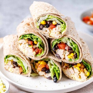 side shot of chicken wraps halves on a plate