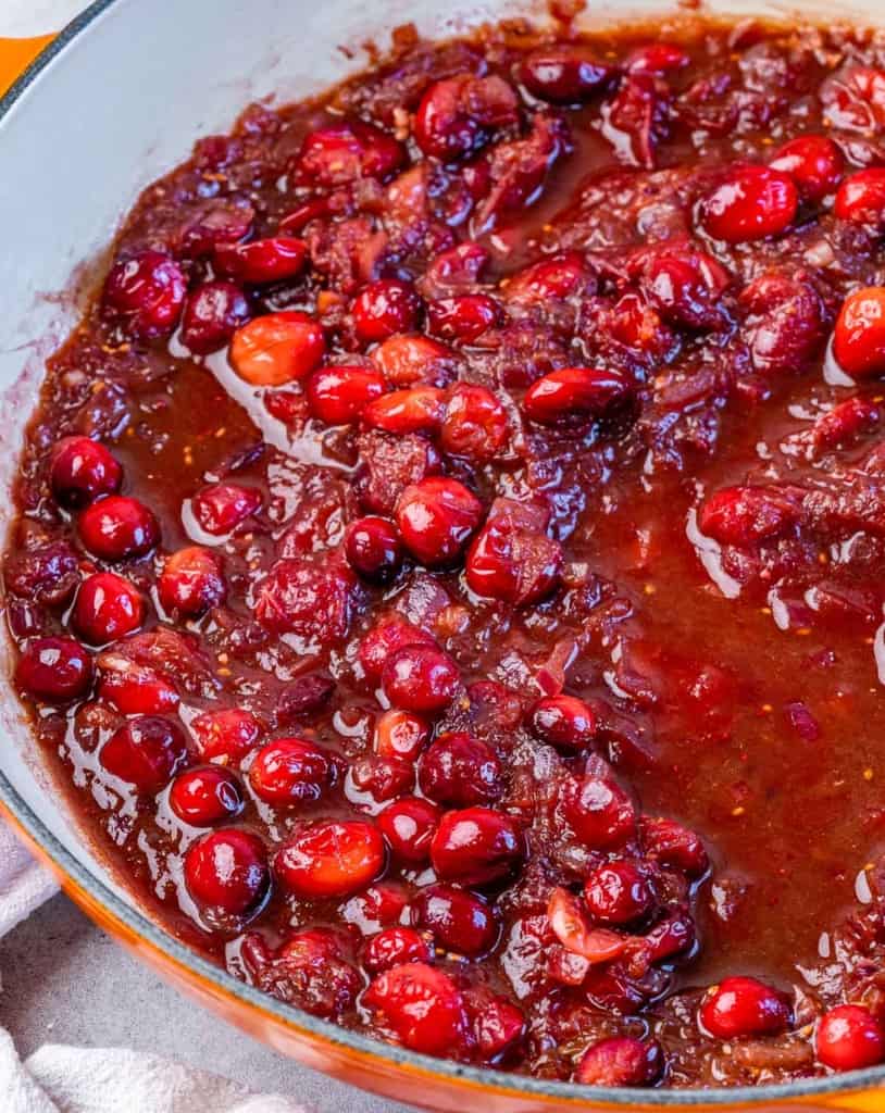 Making cranberry sauce in a large pan.