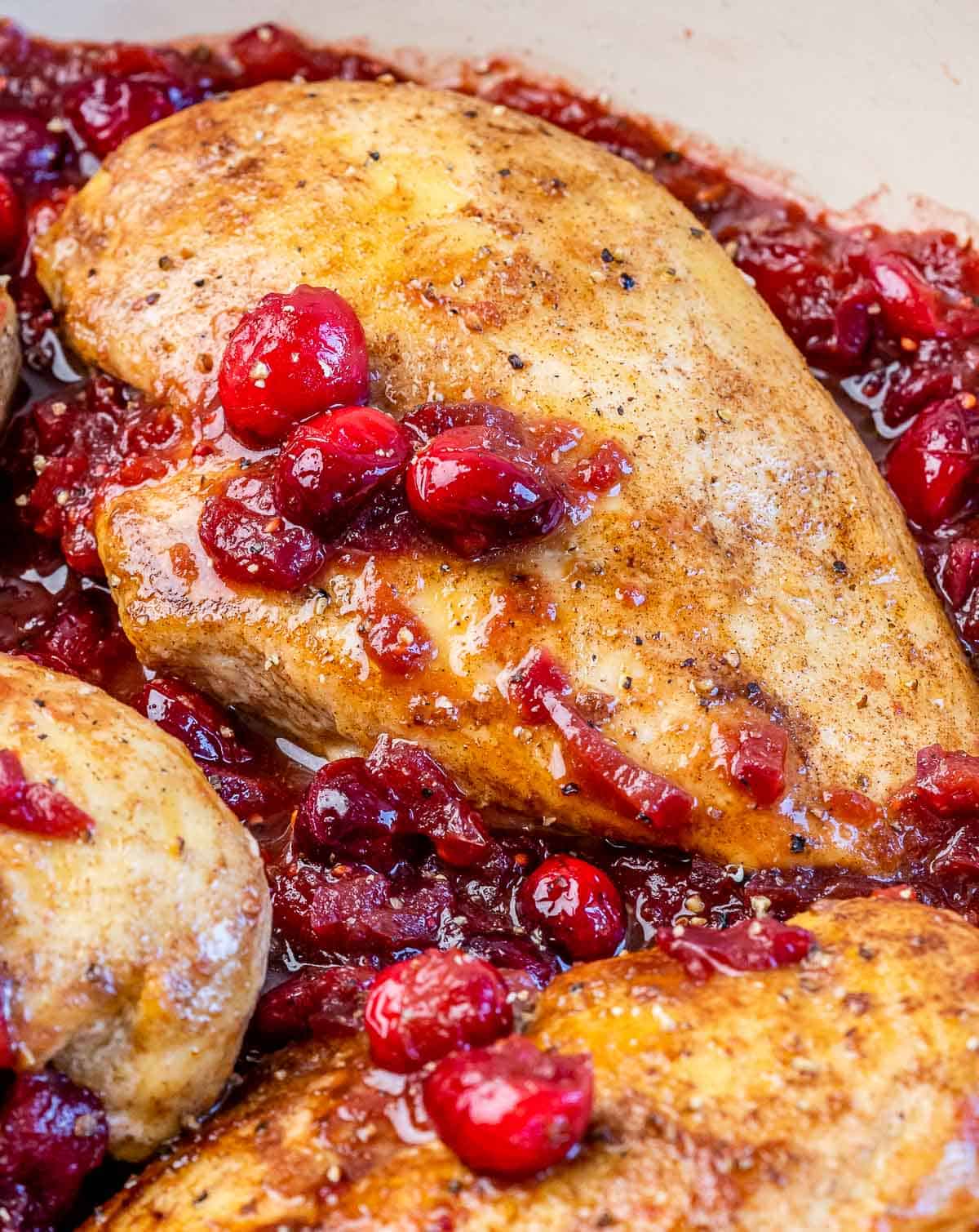 Chicken breast cooked in cranberry sauce.