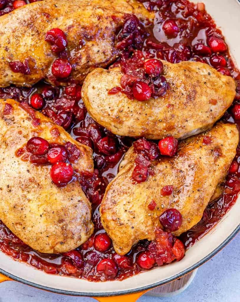 top view of baked chicken breast in cranberry sauce in a pan