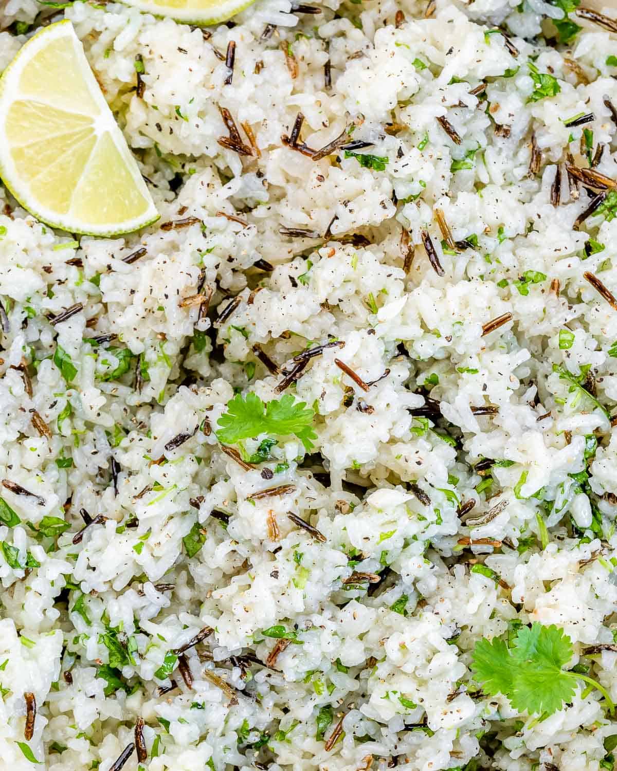 Closeup view of cilantro lime rice served with a lime wedge.