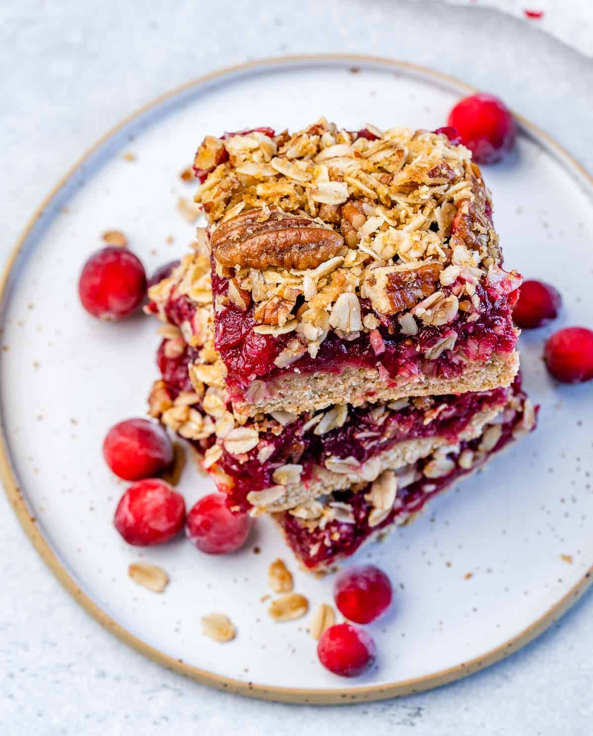 Cranberry bars stacked on a plate.