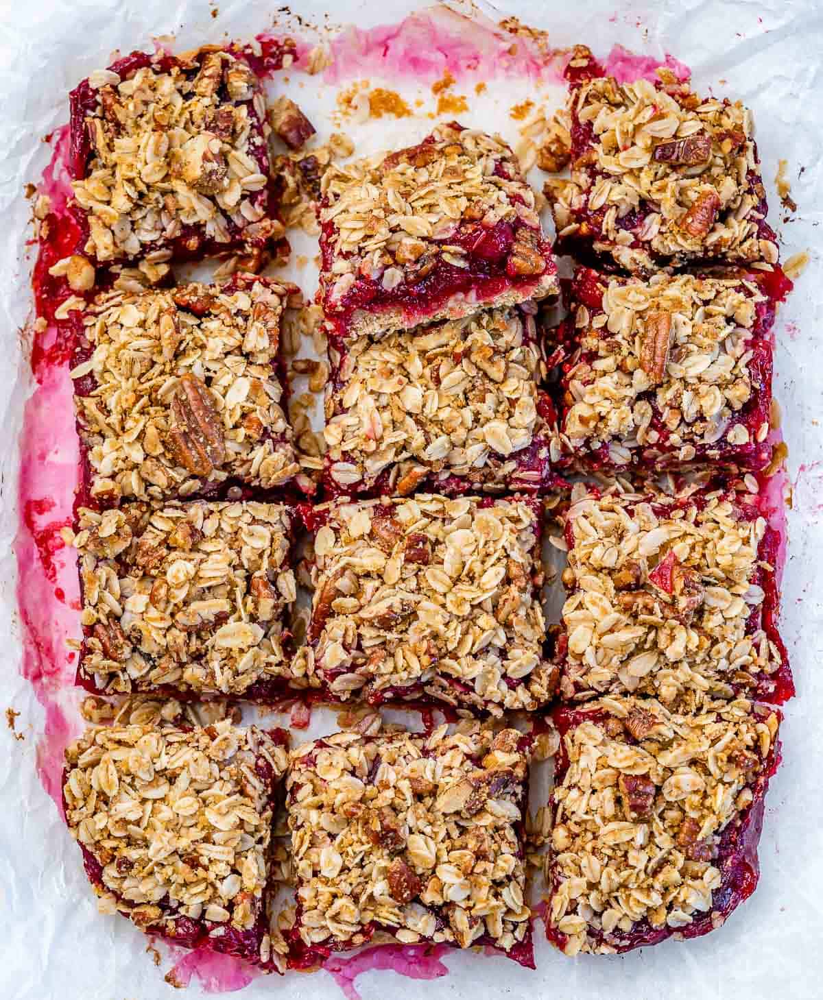 Cranberry bars cut into squares in a pan.