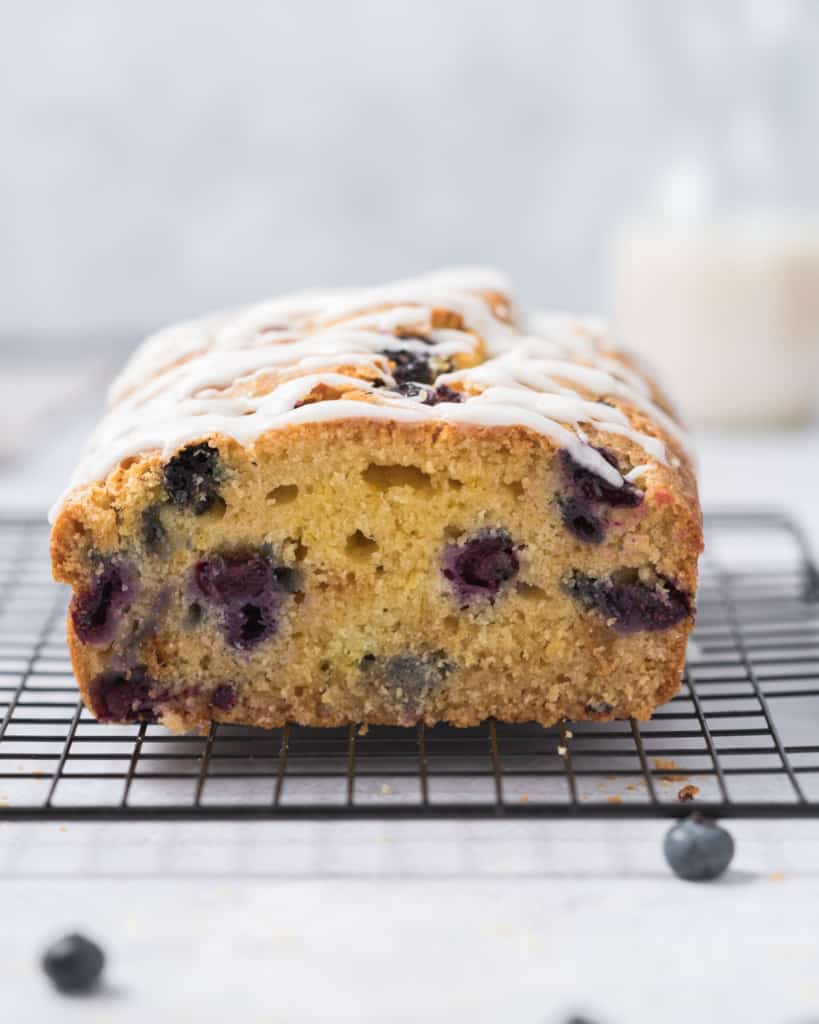 side view of sliced lemon blueberry bread on a wire wrack 