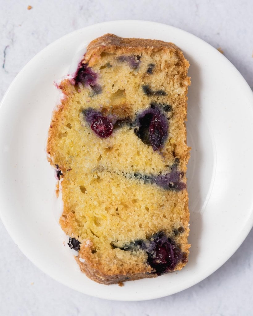 a top view of a slice of blueberry bread on a plate 