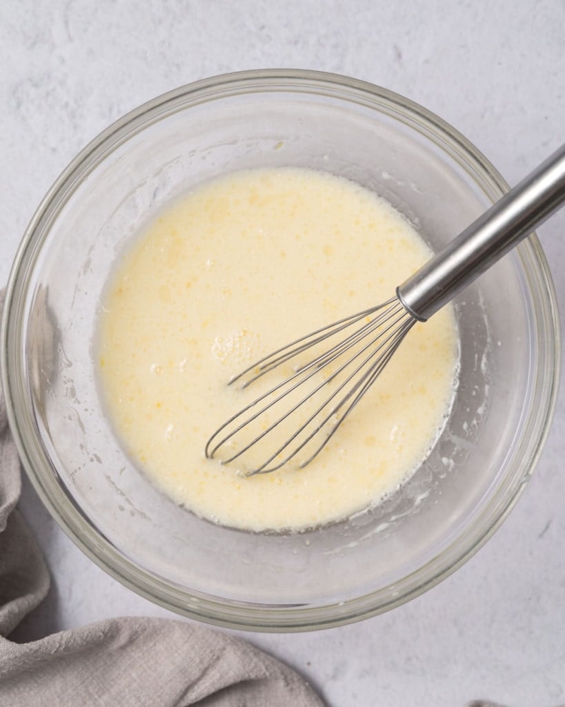 whisk in bowl with blended egg and milk mix 