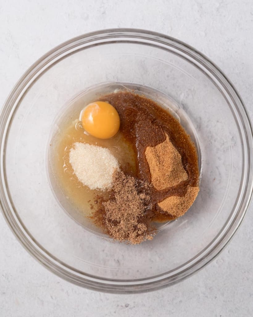 oil and egg added over the sugar in a round bowl