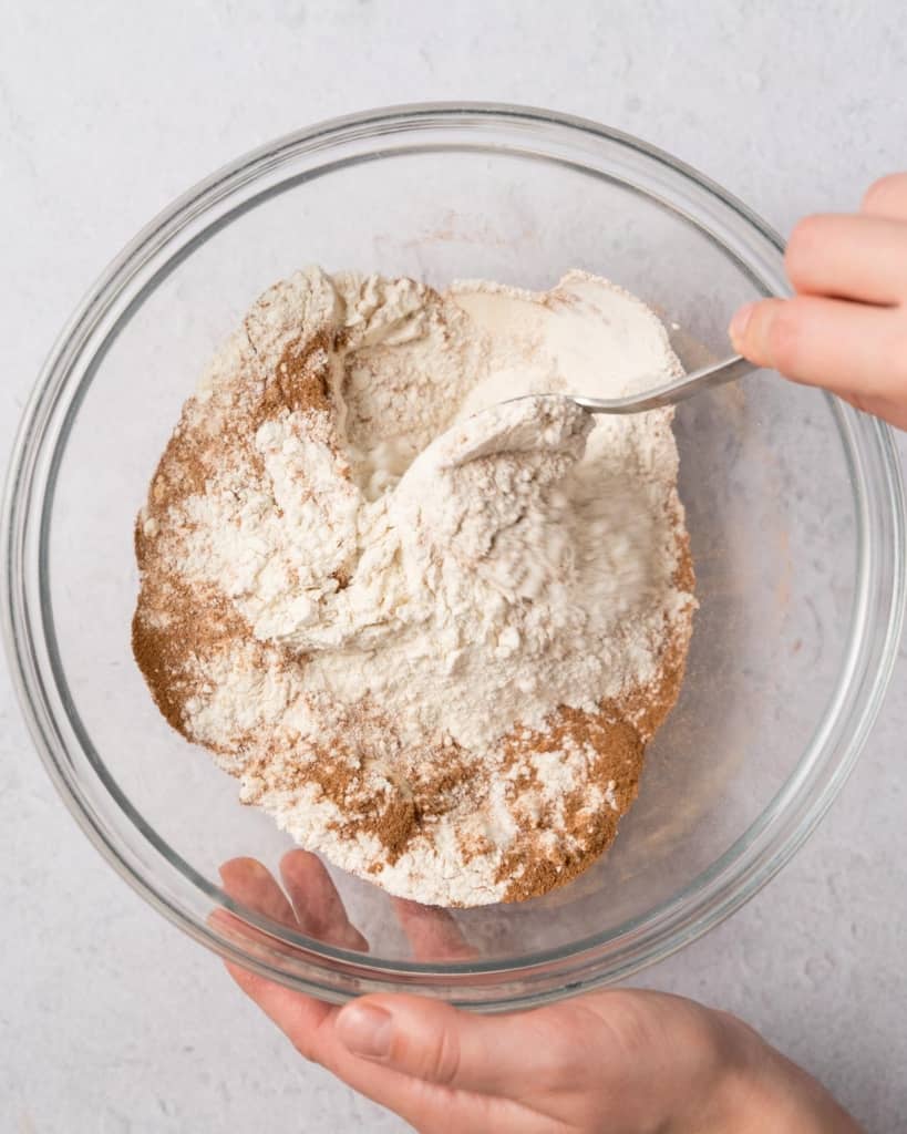 hand holding a fork mixing the flour and spice mix in a bowl
