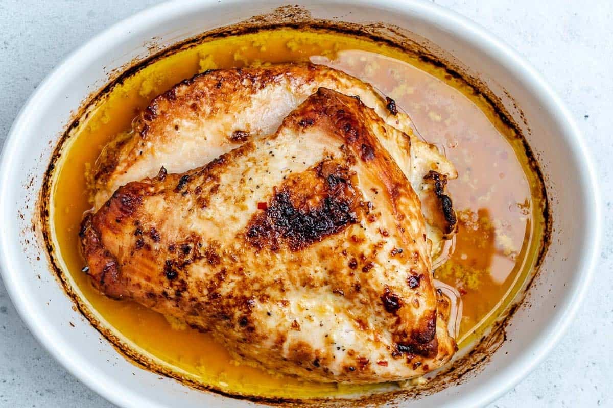 roasted turkey breast in an oval baking dish,