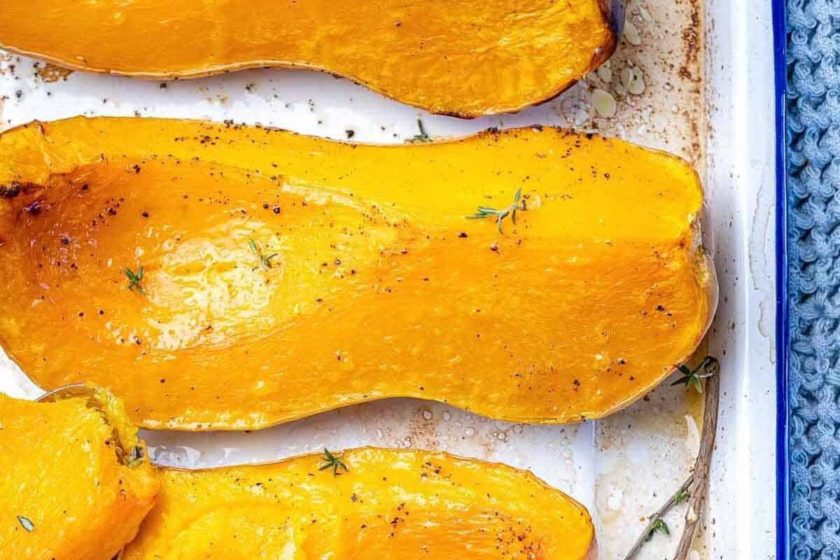 Roasted butternut squash wedges in a pan.