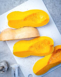butternut squash wedges seasoned with salt and pepper before baking.