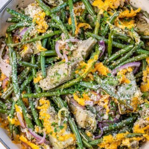 top view of green beans and artichoke casserole topped with melted yellow cheese