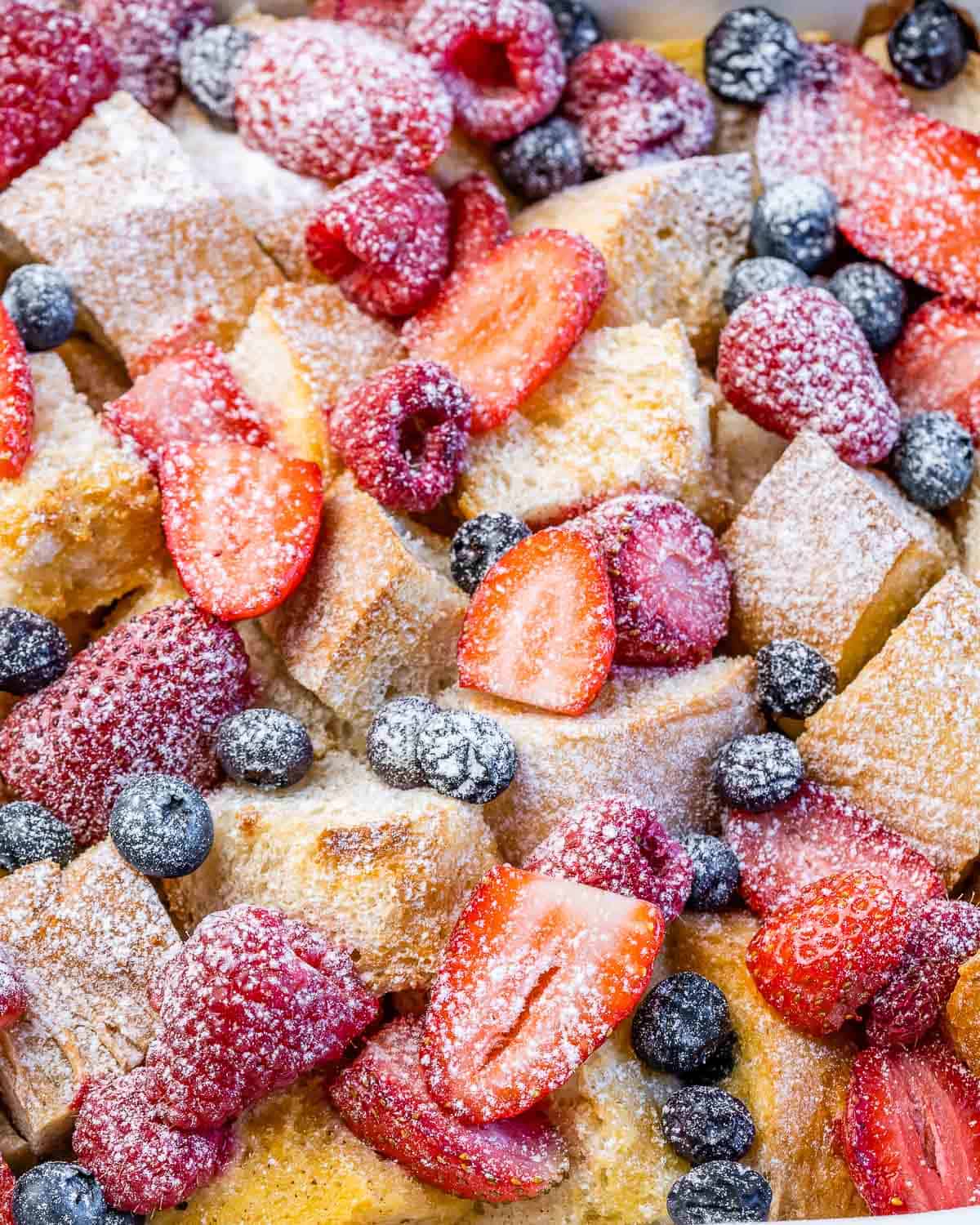 French toast casserole topped with strawberries, blueberries and raspberries.