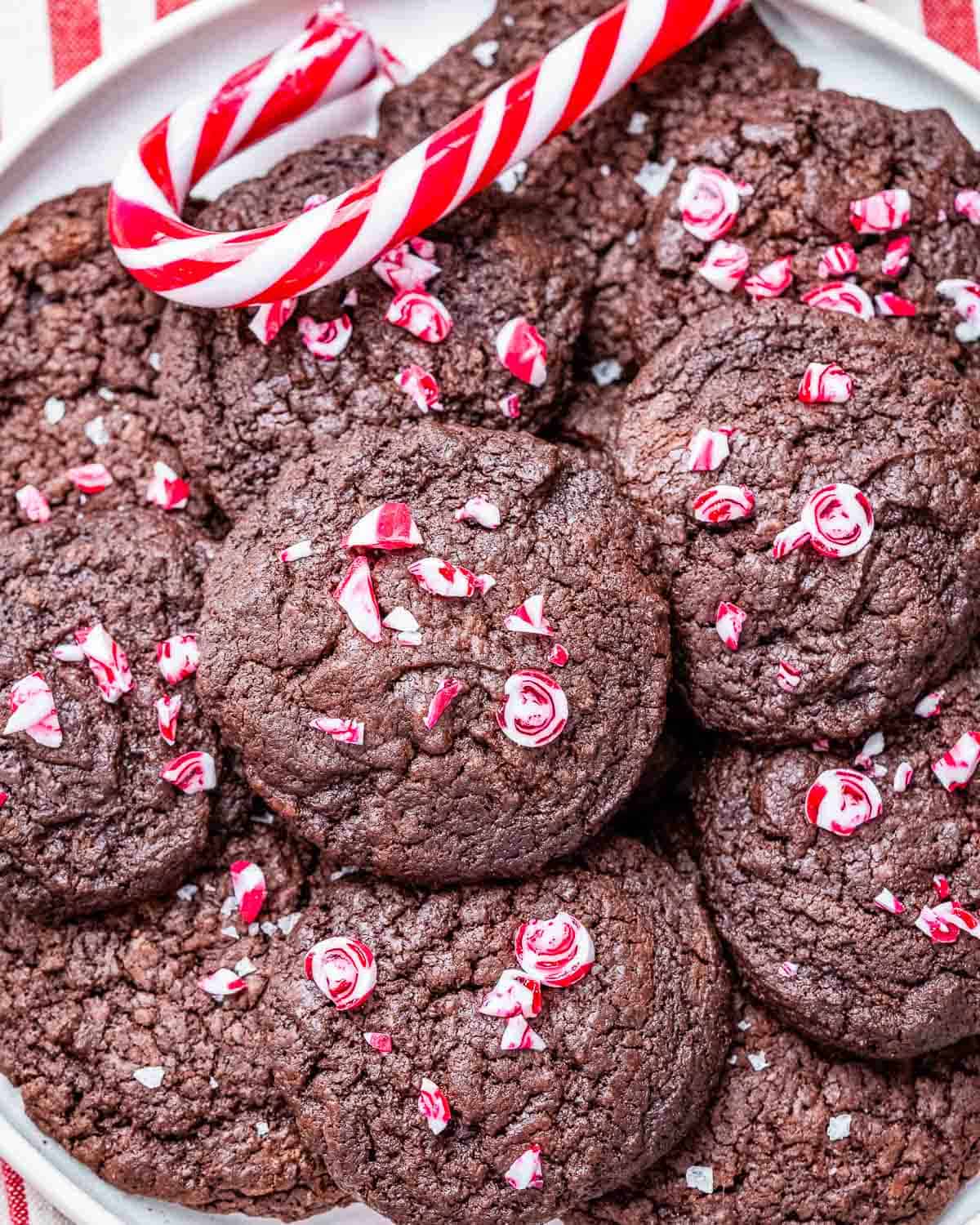 brownie cookies topped with chopped candy cane on a plate.