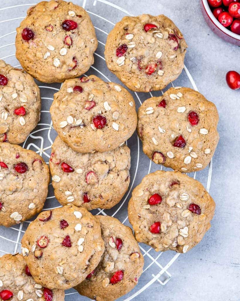 Cookies with cranberries cooling on a wire rack.
