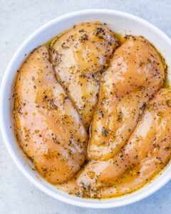 Seasoned chicken breast in a bowl.