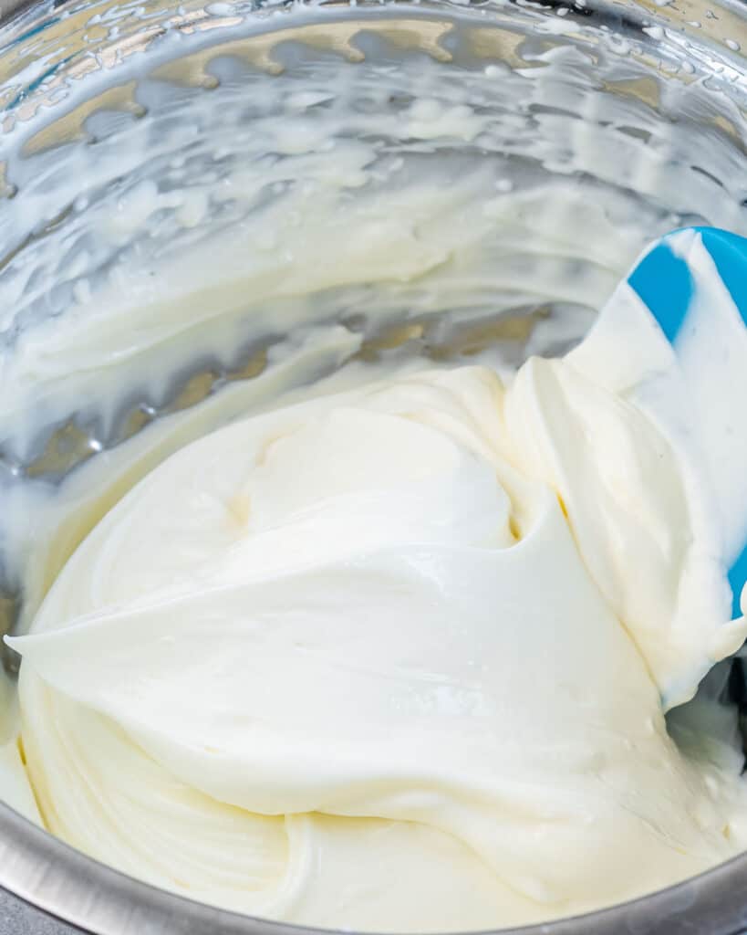 Whipping cream cheese in a food processor.