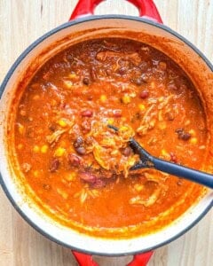 spoon stirring the soup in a pot.