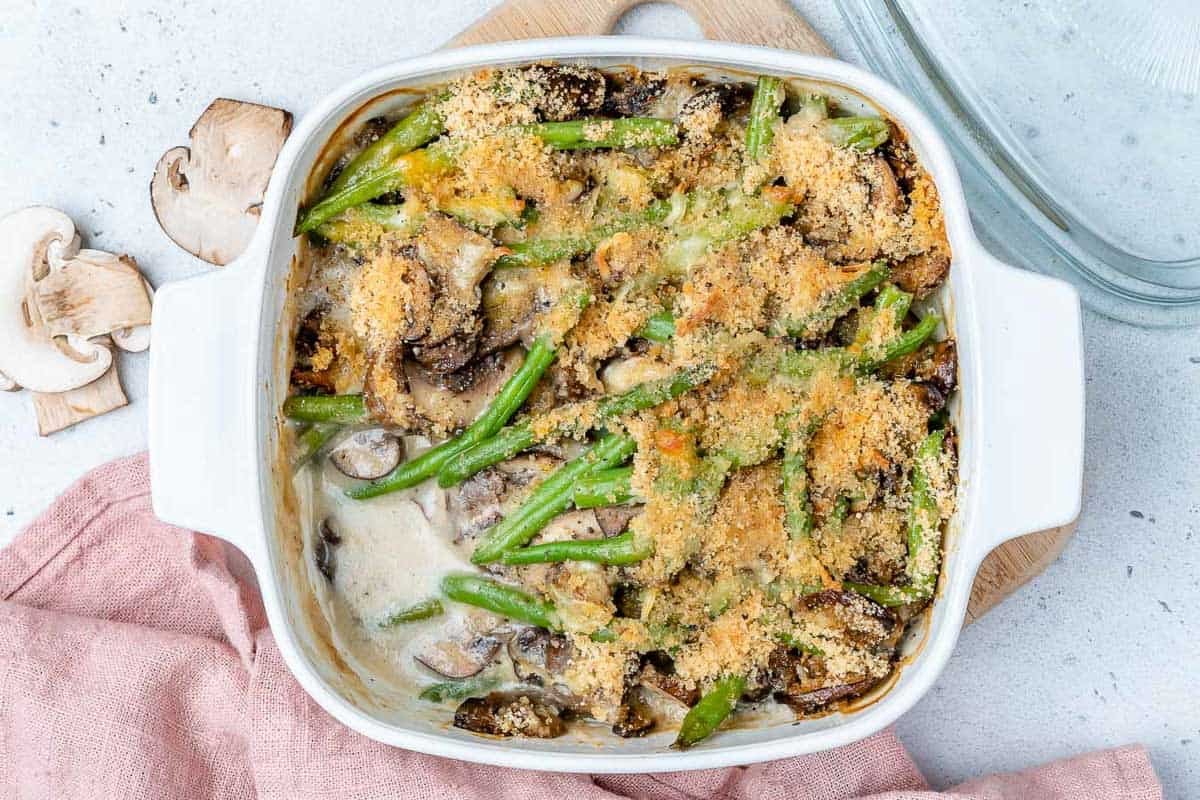 a square dish with healthy green bean casserole, topped with crispy crumbs.