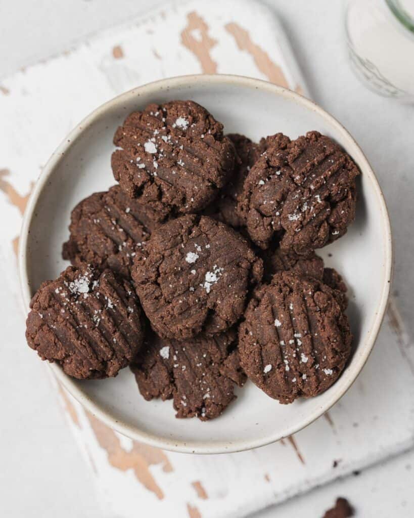 Top view of chocolate cookies on a round white plate.