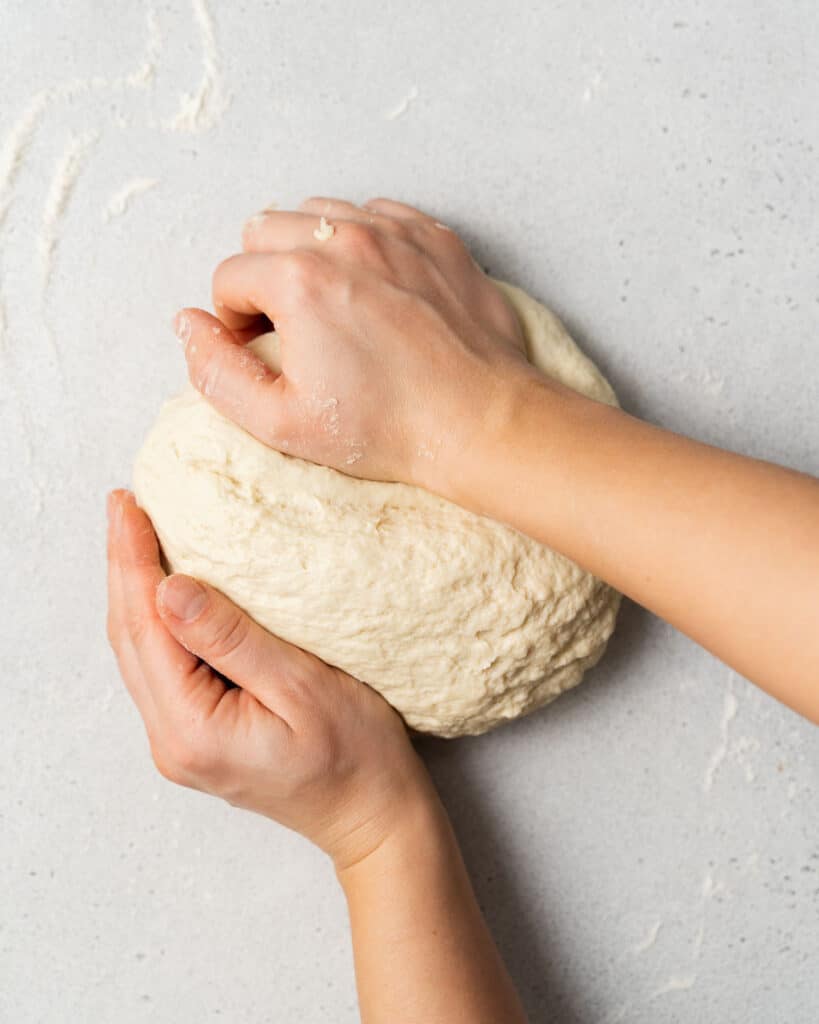Kneading bread on a floured surface.
