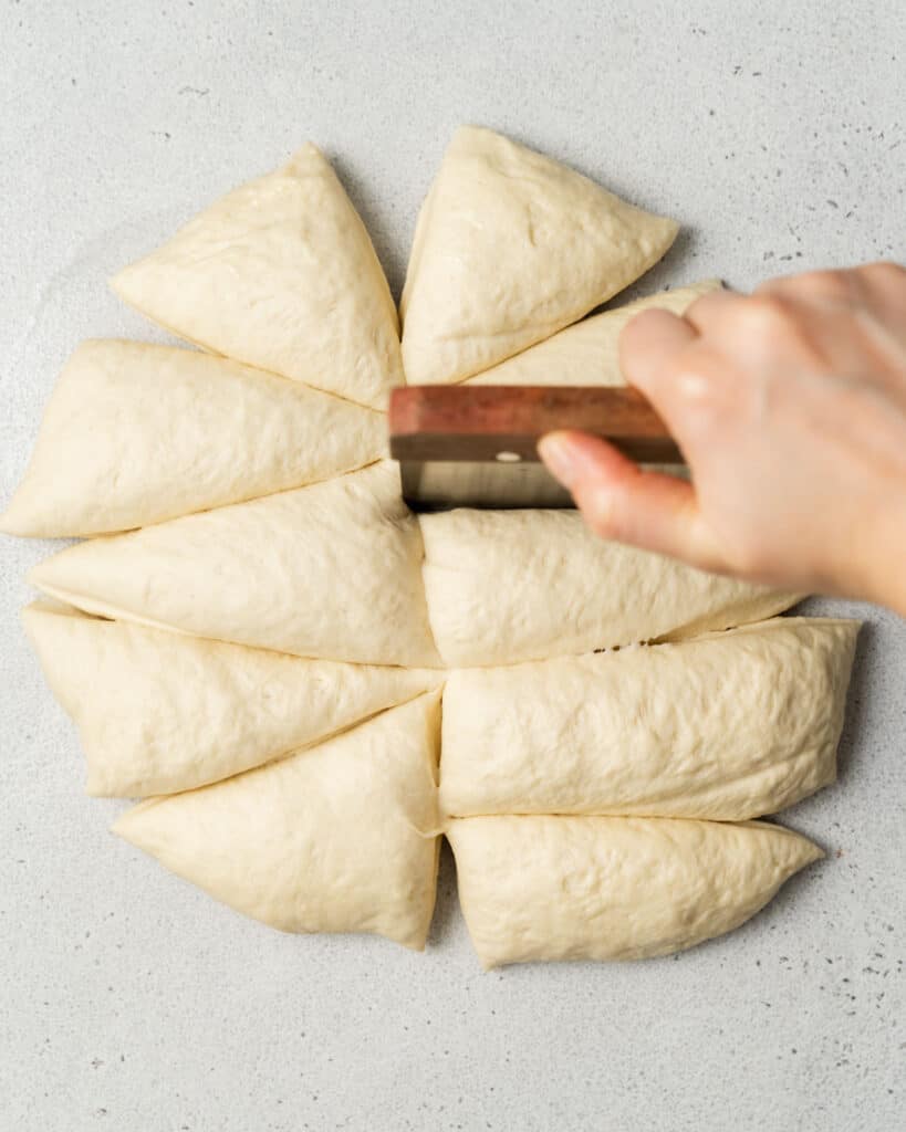 Dividing bread dough into sections.