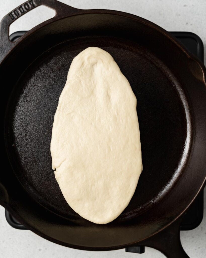 Cooking flatbread in a skillet.