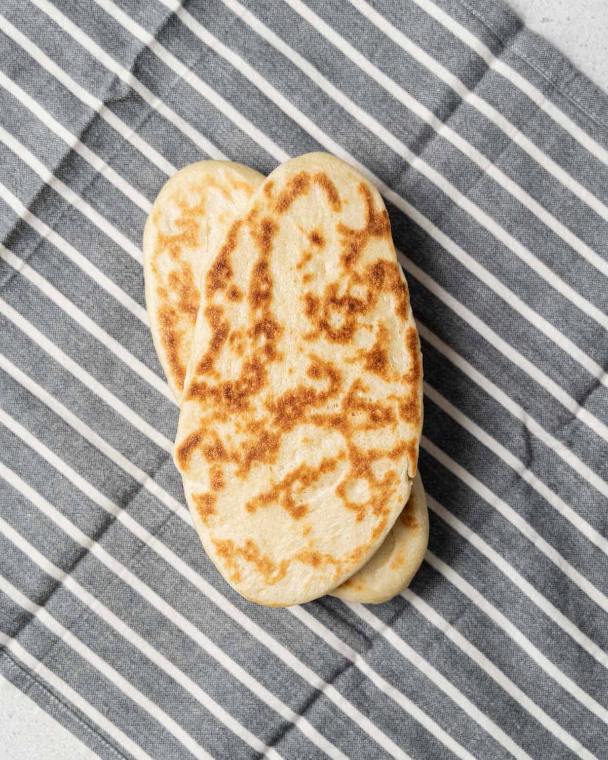 Wrapping naan in a towel.