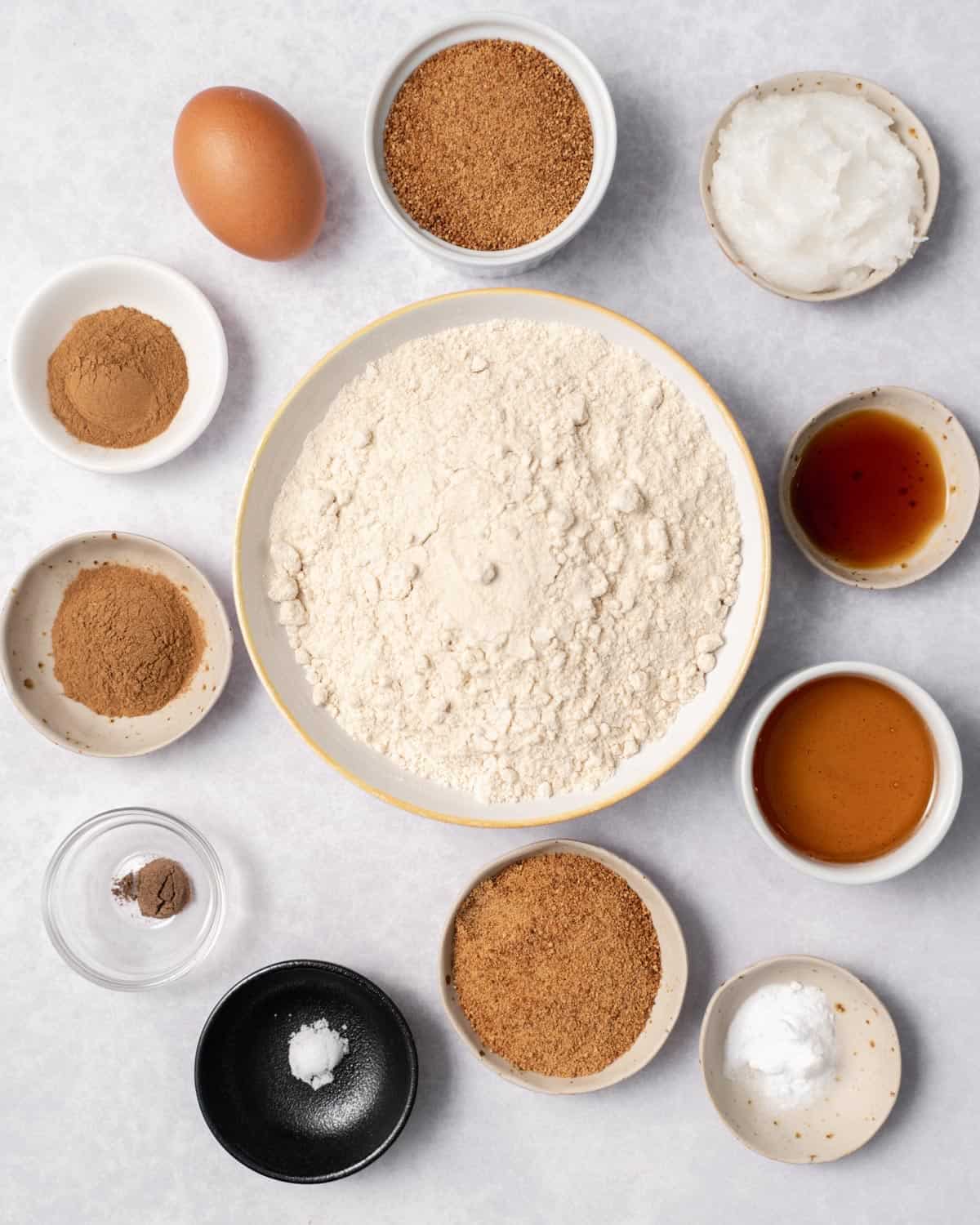 Flour, spices, sugar, coconut oil, egg and vanilla in small bowls.