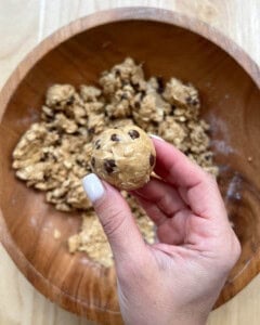 Hand holding a single ball of energy bites.