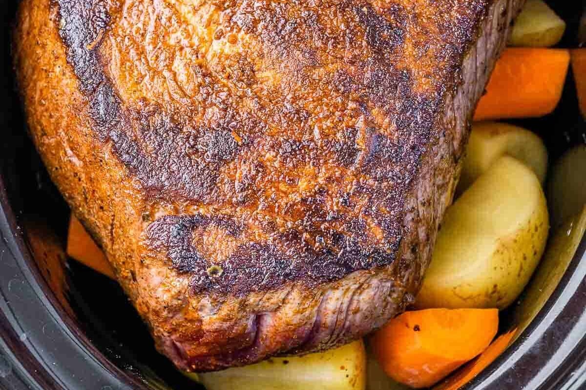 seared rump roast added over veggies in the slow cooker.
