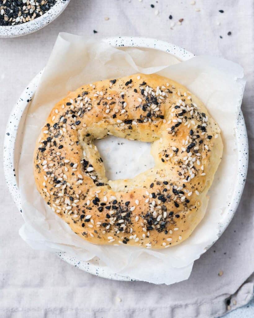 top view of a single baked bagel in a bowl