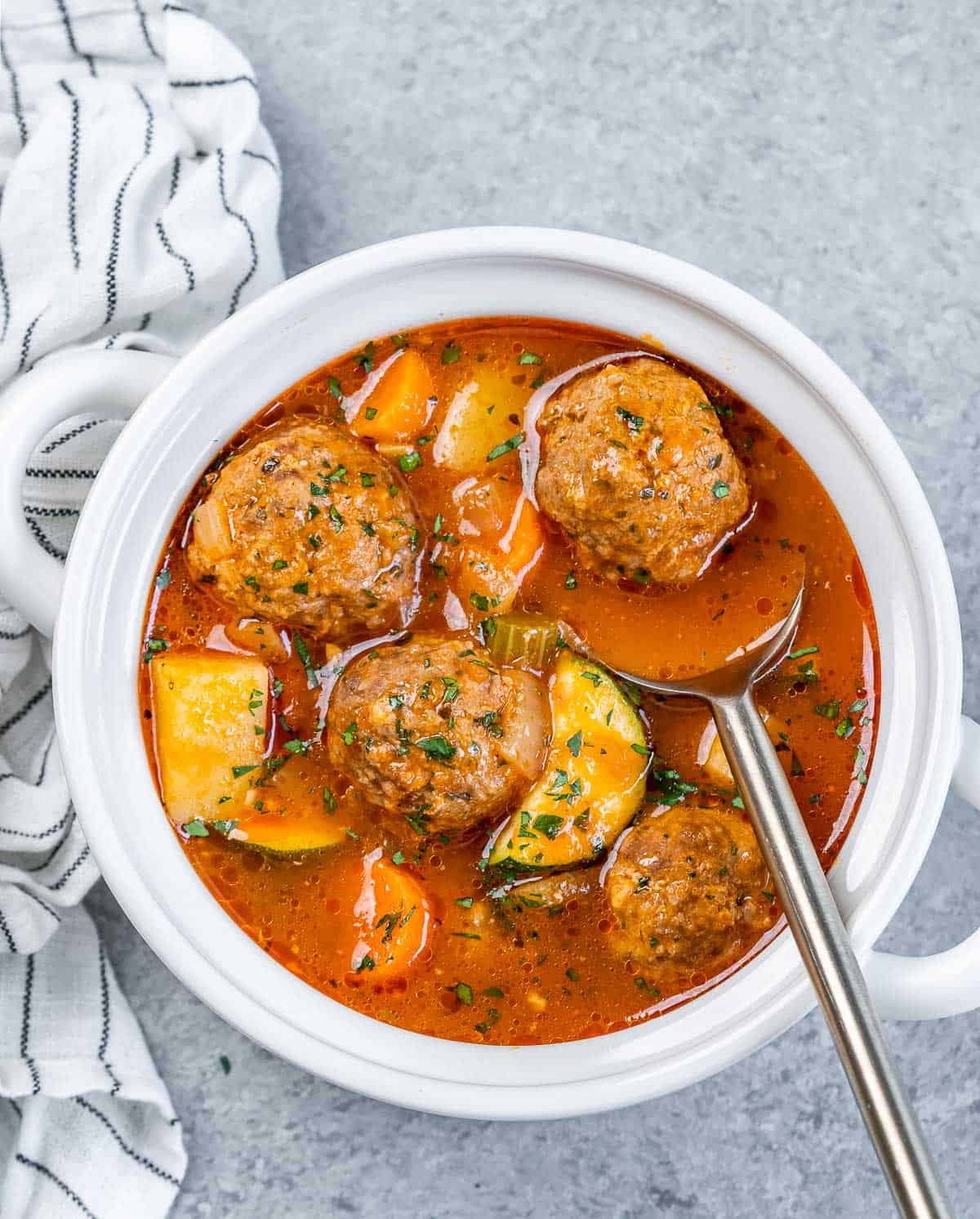Spoon in a bowl of Albondigas Soup.